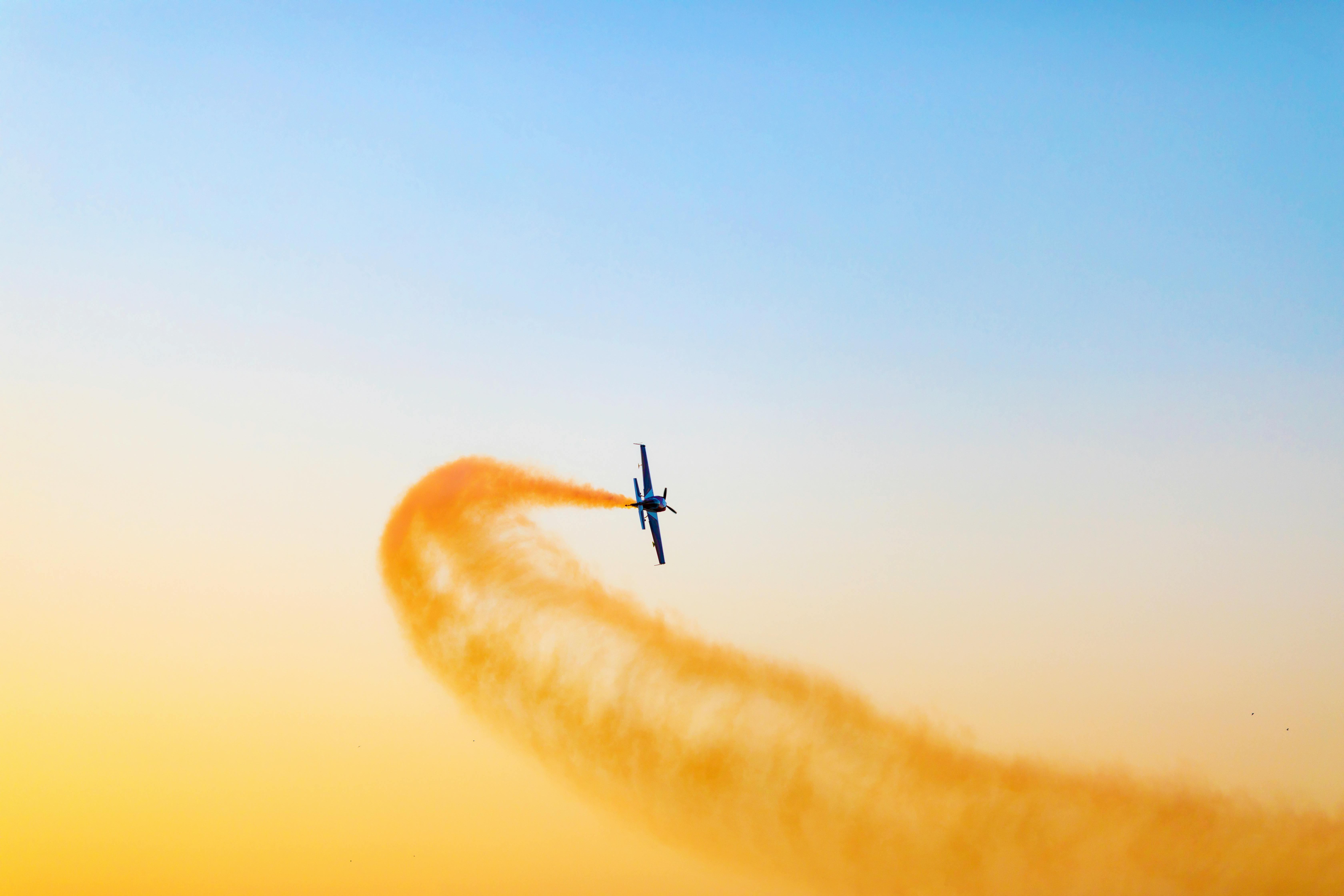 Aircraft banking - leaving yellow smoke trail in its wake