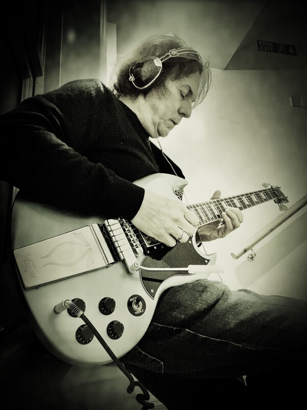 Man playing guitar absorbed in the music he is playing
